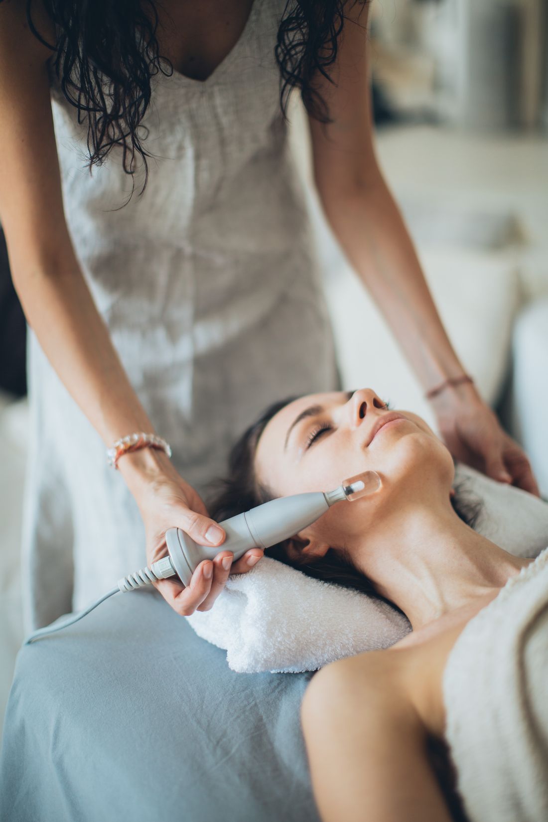 Esthetician performing a hydrating facial treatment